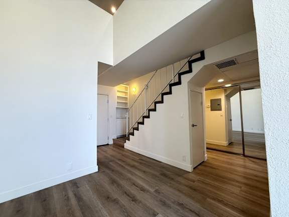 A hallway with a staircase leading to the second floor.