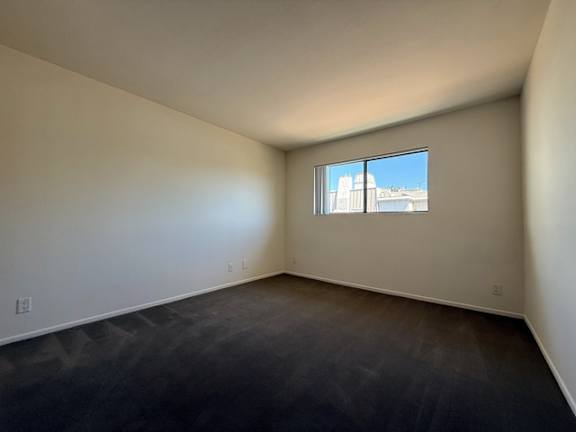 Empty room with a window and a concrete floor.