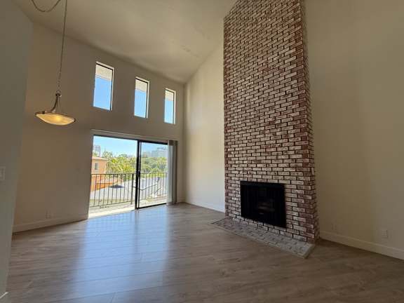 A room with a fireplace and a sliding glass door.