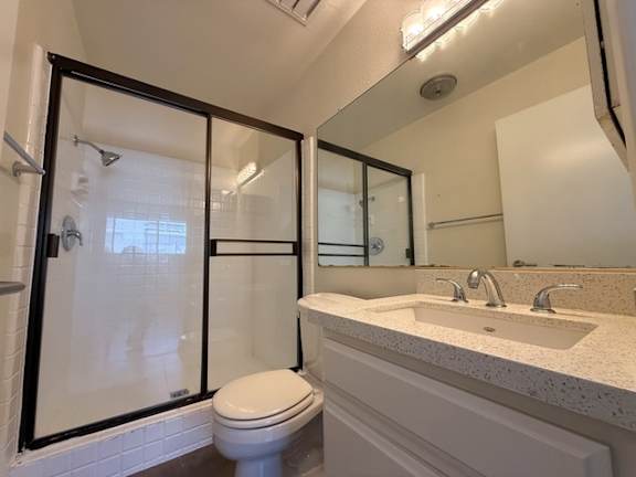 A white toilet sits next to a sink in a bathroom.