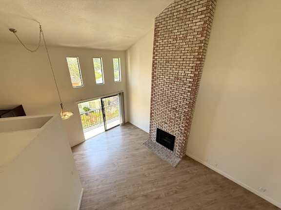 A room with a fireplace and a brick wall.
