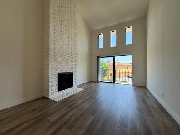 A room with a fireplace and sliding glass doors.