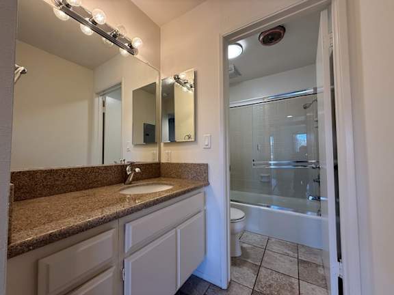 A bathroom with a sink, mirror, and shower.