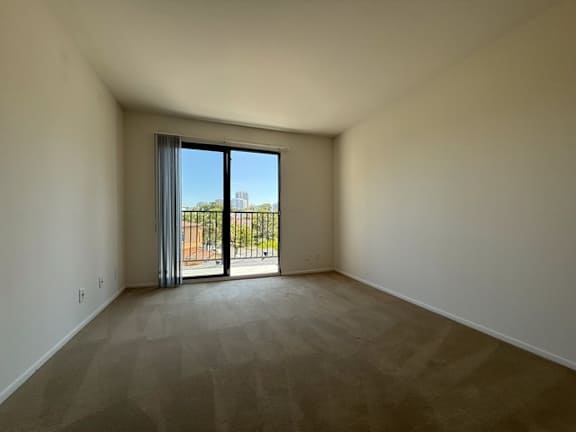 Empty room with a sliding glass door.