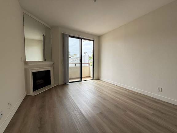 A room with a fireplace and sliding glass doors.