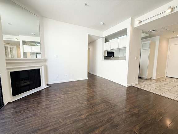 A living room with a fireplace and a television.