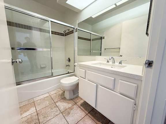 A bathroom with a toilet, sink, and shower.