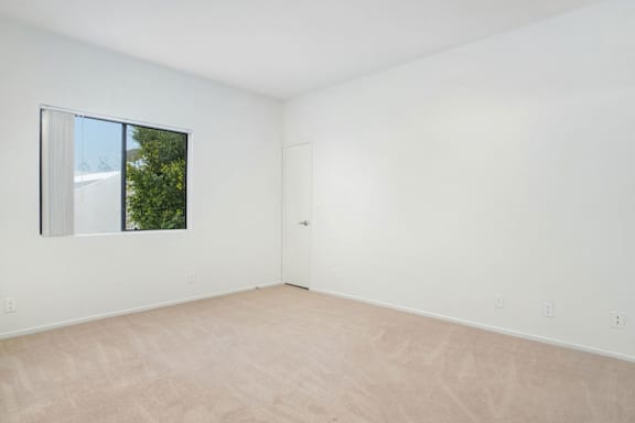 A room with a large window and a door.