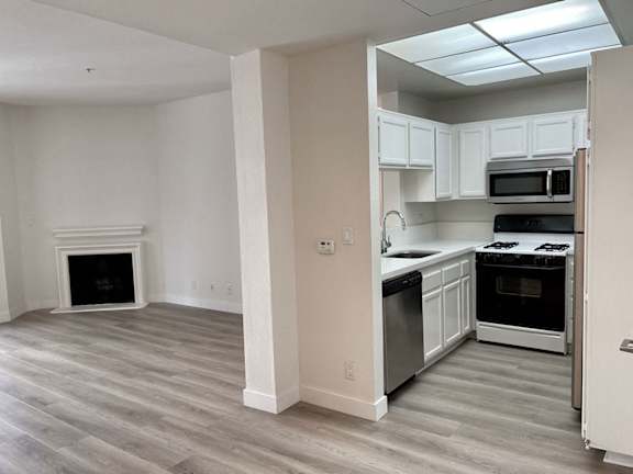 A kitchen with a stove top oven and a microwave.