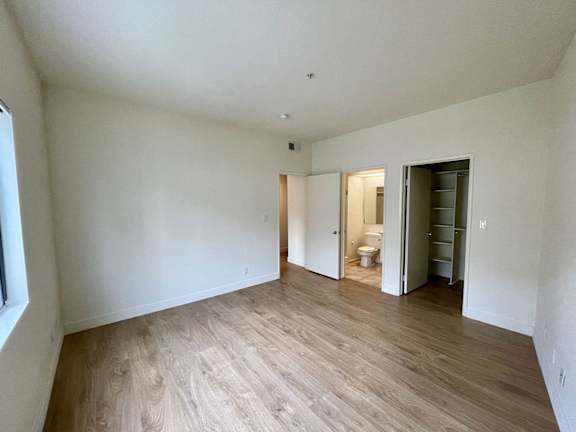 A room with a wooden floor and white walls.