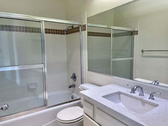 A white toilet sits next to a sink in a bathroom.