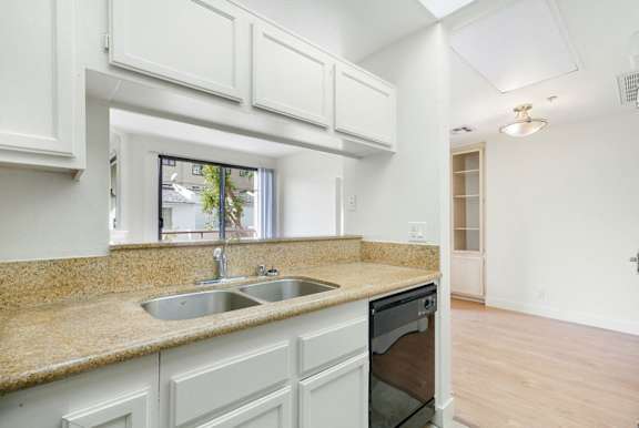 A kitchen with a sink and a window.