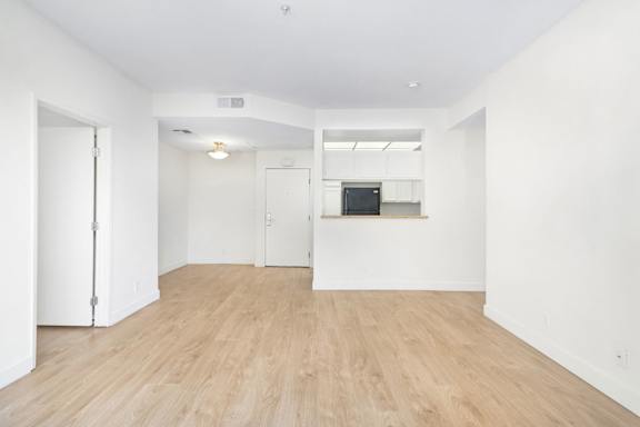 A room with wooden floors and white walls.