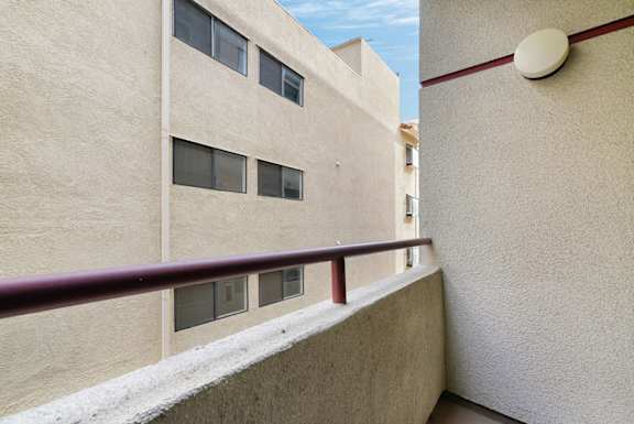 A building with a red railing and windows.