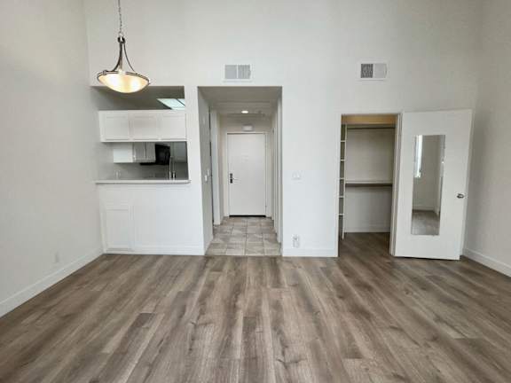 A room with a wooden floor and white walls.