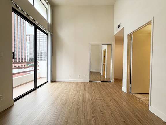 A room with a wooden floor and a large window.