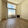 A room with a window and sliding glass doors.