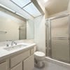 A white toilet sits next to a sink in a bathroom.