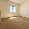 A room with a window and a white wall.