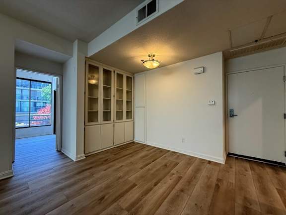 A room with wooden floors and white walls.
