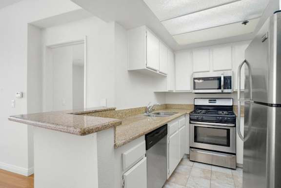 A kitchen with granite countertops and stainless steel appliances.