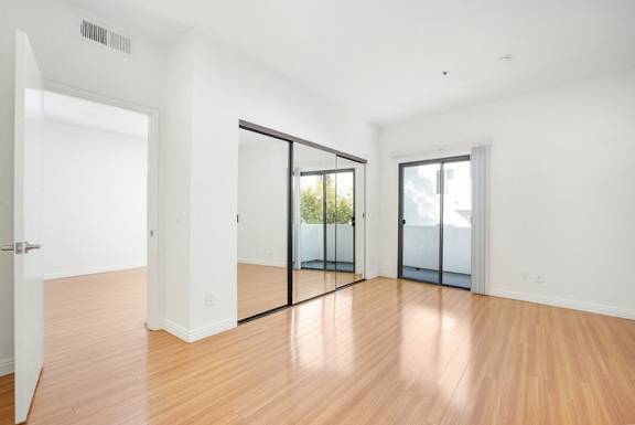 A room with wooden floors and white walls.