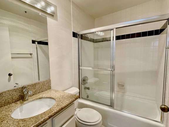 A bathroom with a sink, toilet, and shower.