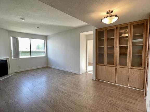 A room with wooden floors and a fireplace.