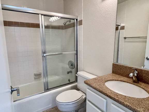 A bathroom with a toilet, sink, and shower.