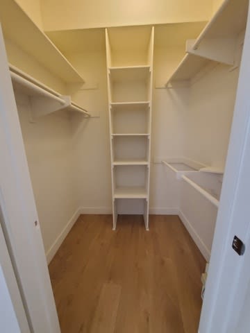 A small white closet with a ladder.