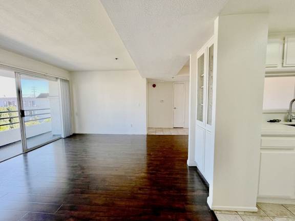 A room with a wooden floor and white walls.