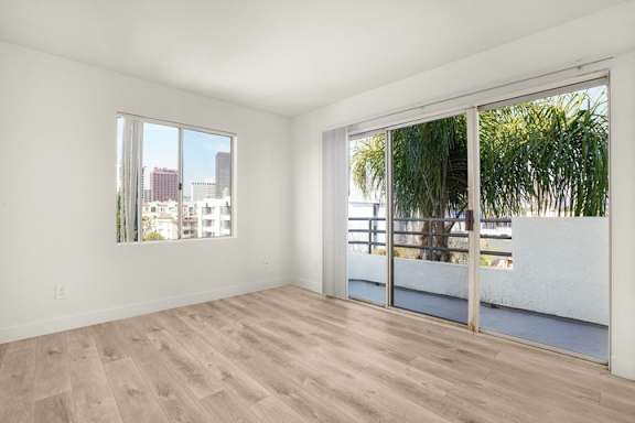 A room with a view of the city through a window.
