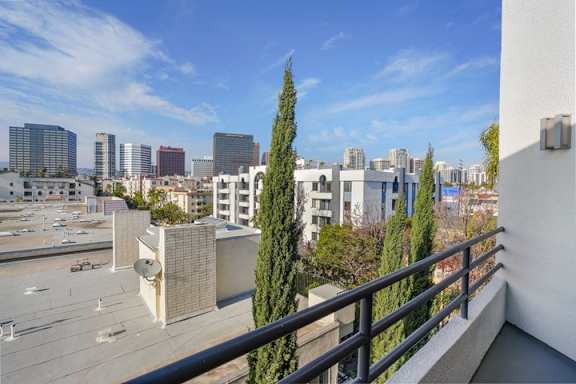 A cityscape with buildings and trees in the foreground.