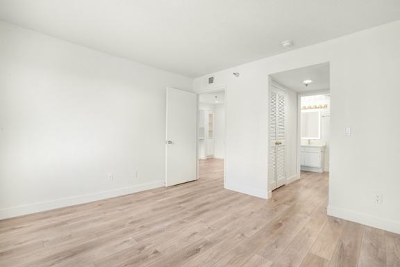 A room with white walls and wooden flooring.