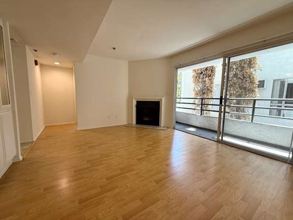 A living room with a fireplace and sliding glass doors.