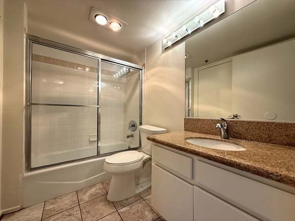 A bathroom with a toilet, sink, and shower.
