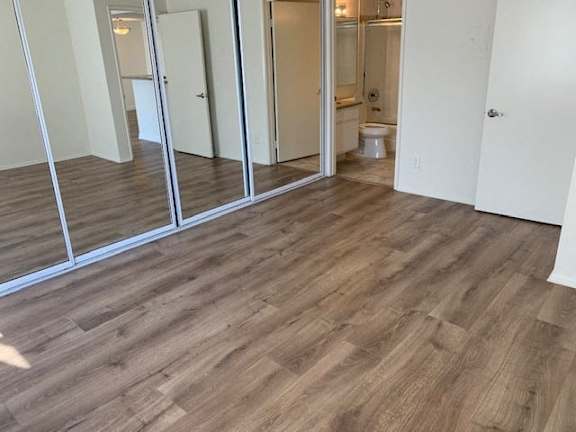 A room with wooden flooring and a glass door.