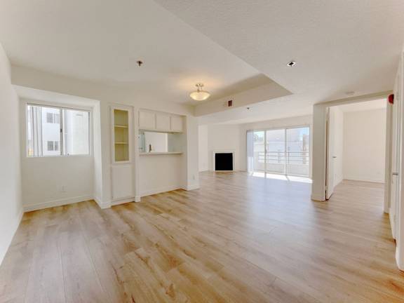 A room with wooden floors and white walls.