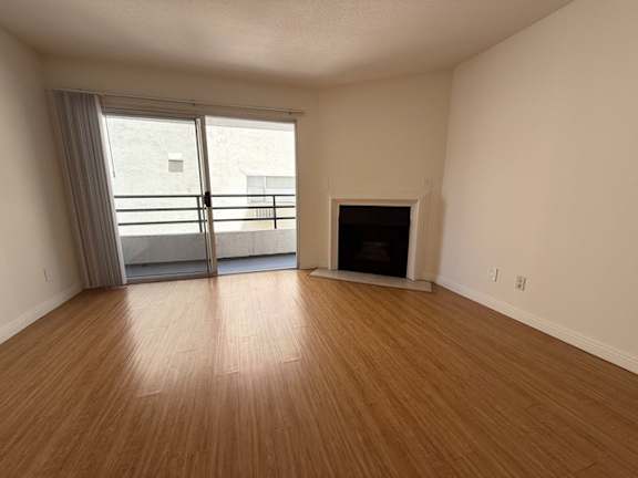 A room with a fireplace and sliding glass doors.
