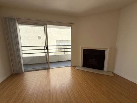 A room with a fireplace and sliding glass doors.