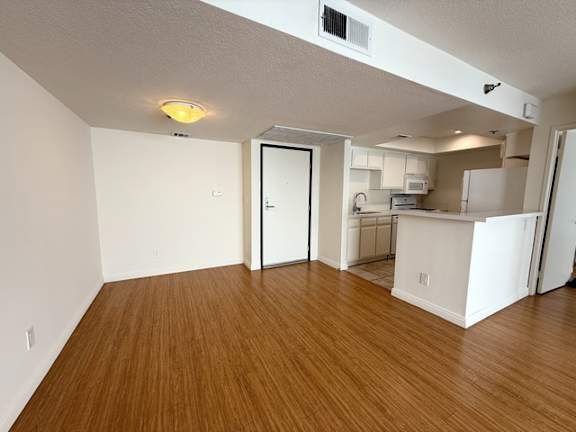 A room with wooden floors and white walls.