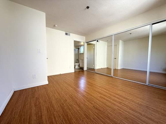 A room with wooden floors and white walls.