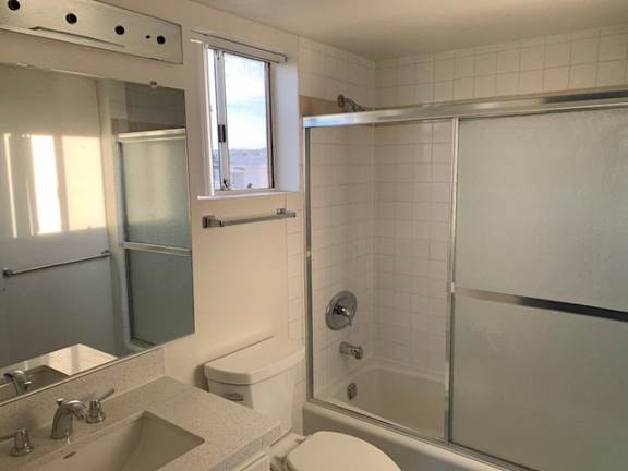 A bathroom with a sink, toilet, and bathtub.