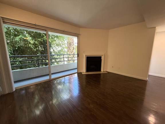 A living room with a fireplace and sliding glass doors.