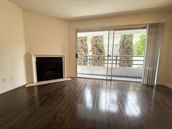 A room with a fireplace and sliding glass doors.