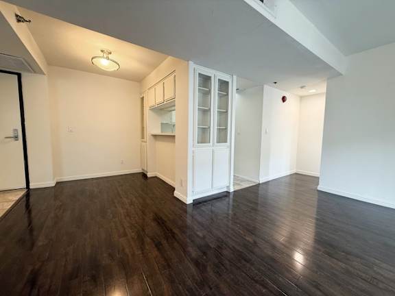 A room with wooden floors and white walls.