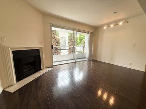 A room with a fireplace and sliding glass doors.
