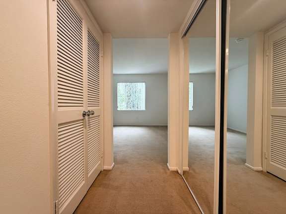 A room with a white door and a window.
