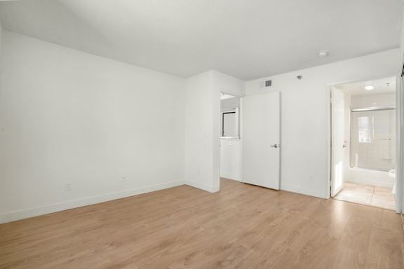 Empty room with wooden floors and white walls.