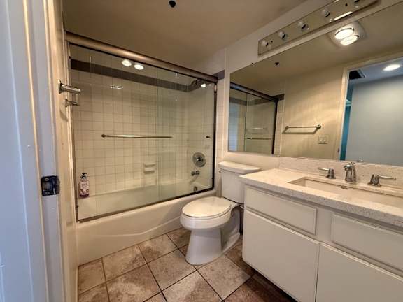 A white bathroom with a toilet, sink, and shower.